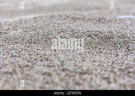 Close-up of texture beige or multi-colored fine sand with copy space.Focus on middle ground. Sandy natural background.Surface of sand dune Selective f Stock Photo