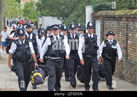 Notting Hill, London, UK. 28th Aug, 2022. Londoners and tourists alike enjoy the second day of Notting Hill Carnival under strong police presence. Credit: Uwe Deffner/Alamy Live News Stock Photo