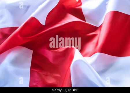 A closeup shot of deep tones of the ruffled flag of England Stock Photo