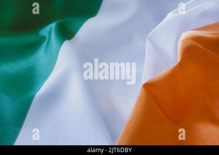 A closeup shot of deep tones of the ruffled flag of Ireland Stock Photo