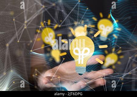 A blurred shot of a man touching lamp icons - shows the concept of new ideas Stock Photo