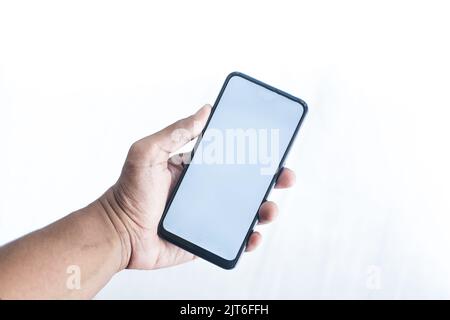 young man hand using smart phone against white wall  Stock Photo