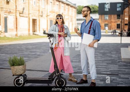 Stylish colleagues meet together outdoors Stock Photo