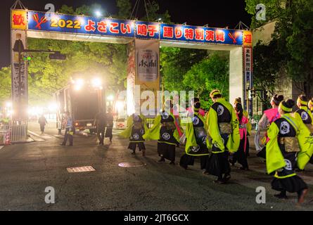 Kochi, Japan - August 10, 2022: Performers enter through bright lights to main stage at Yosakoi Festival Stock Photo