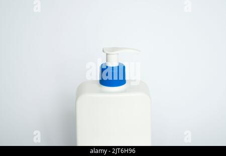 White unbranded plastic dispenser pump bottle on white background. Cosmetic package mockup, liquid soap flacon, hand sanitizer without label, shampoo Stock Photo