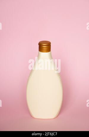 Beige blank plastic bottles isolated on pink background. Stock Photo