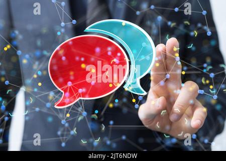 A man's hand pressing digital icons with colorful dialog speech bubbles Stock Photo