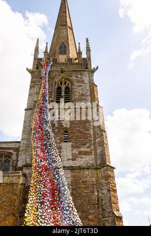 The north tower of All Saints church in Middleton Cheney decorated with crochet flower and animals Stock Photo