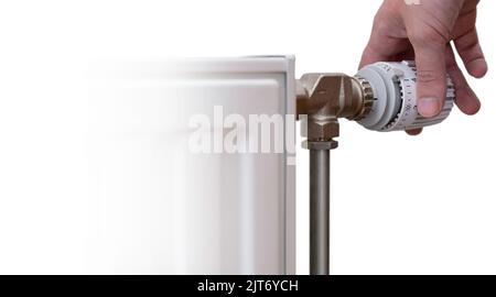 Hand turns the thermostatic tap to turn the heating down. Isolated on white with heating radiator. Left space for text or design Stock Photo