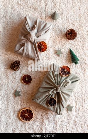 Christmas gifts textile packed, decorated with natural materials, top view, zero waste concept Stock Photo