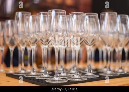 Set of new bar glassware on the bar counter. lots of empty glasses. Stock Photo