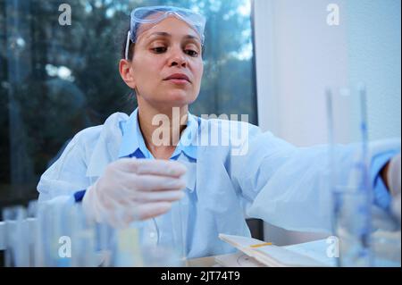 Medical scientist, pharmacologist working on a new generation experimental drug in a clinical research laboratory Stock Photo