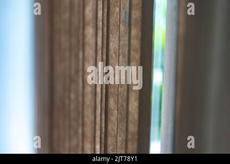 Curtain of shutters installed in window. Decoration. Tool to cover windows. Sun cover. The shutters are formed by slanted slits or fins that allow ven Stock Photo
