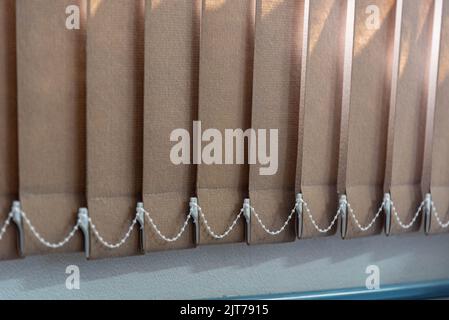 Curtain of shutters installed in window. Decoration. Tool to cover windows. Sun cover. The shutters are formed by slanted slits or fins that allow ven Stock Photo