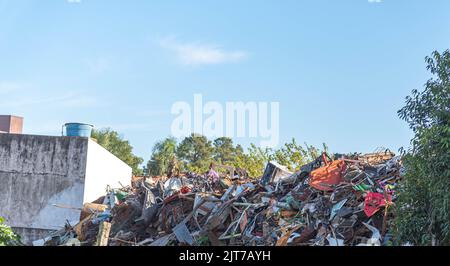 Electronic waste deposited in the open. Environmental disaster. Deposit of waste and synthetic material. Irregular environmental disposal. Non-organic Stock Photo