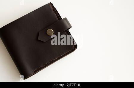 Brown natural genuine leather wallet isolated on white background. Expensive man's purse closeup. Stock Photo
