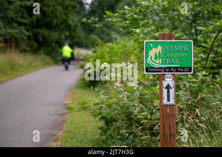 Sequim, WA USA - 07-18-2022: Olympic Discovery Trail with bicycle rider in soft focus in distance Stock Photo