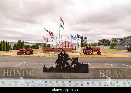 Sequim, WA USA - 07-18-2022: Sequim Museum and Arts Building with War Memorial in Foreground Stock Photo