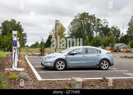 Sequim, WA USA - 07-18-2022: Enel X Electric Vehicle Charging Station with a Chevy Volt being refueled Stock Photo