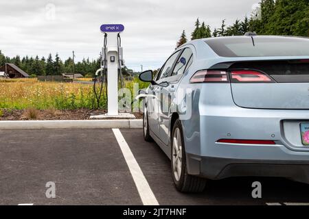 Sequim, WA USA - 07-18-2022: Enel X Electric Vehicle Charging Station with a Chevy Volt being refueled Stock Photo
