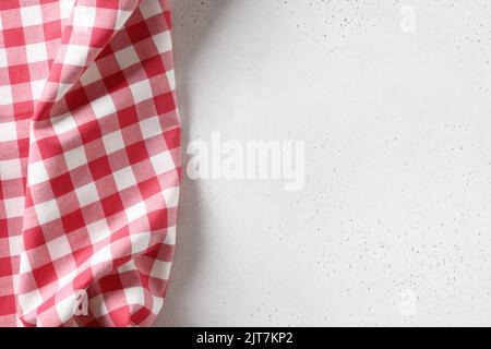 Kitchen white table with red checkered towel. Top view. Copy space. Stock Photo