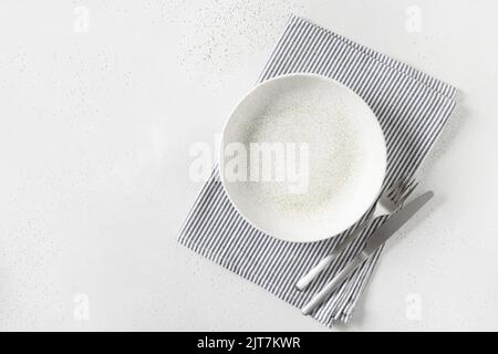 White empty plate with towel on white background. Stock Photo