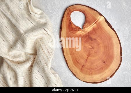 Cutting board and coasters on a gray concrete table with a kitchen towel. Food display template. Top view with copy space Stock Photo