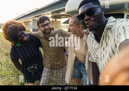 multiethnic group of friends taking a selfie and smiling to the camera. High quality photo Stock Photo