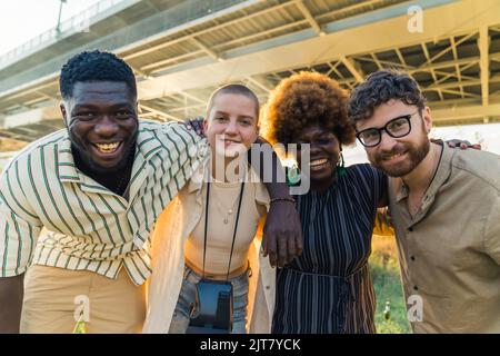 multiethnic friends taking a commemorative photo together, medium shot outdoors friendship concept. High quality photo Stock Photo