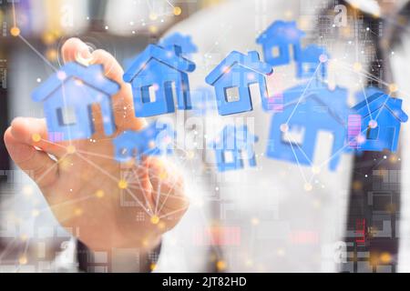 The hand tapping at the network of houses - real estate concept Stock Photo