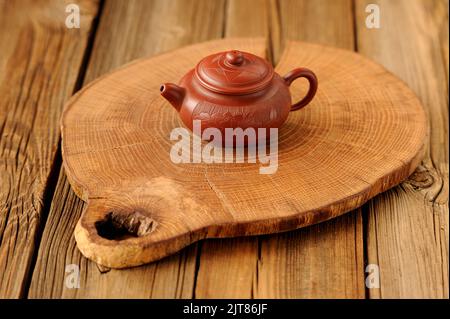 Small yixing red clay teapot on wooden board horizontal Stock Photo