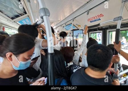 A closeup of people with masks on a crowded bus in the coronavirus pandemic, Beijing, China Stock Photo