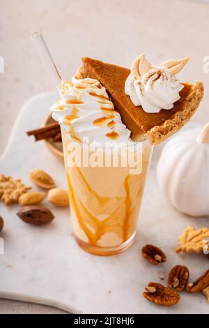Pumpkin pie milkshake with caramel syrup and whipped cream Stock Photo