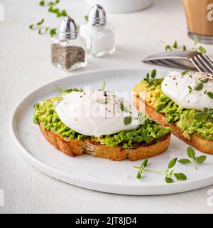 Avocado toast with a poached egg on top Stock Photo