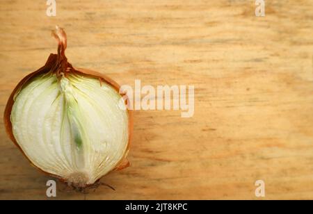 wilted onions on a wooden cutting board Stock Photo