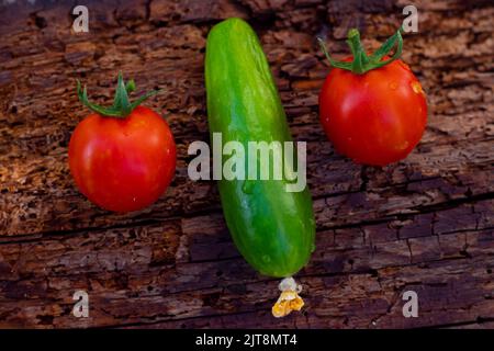 Vegetables on wooden background. tomatoes and salad. wet vegetables. taken from the top.selective focus. Stock Photo