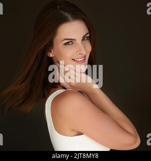 True beauty always shines through. Studio portrait of an attractive young woman posing against a black background. Stock Photo