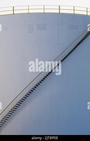 White oil storage tank with black metal staircase at oil and gas refinery, Montreal East, Quebec, Canada. Stock Photo