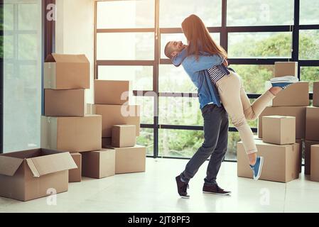 Its a new beginning worth celebrating. a happy young couple celebrating their move into a new home. Stock Photo