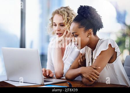 Working together to meet their objectives. two designers working together in the office. Stock Photo