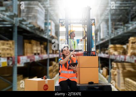 Manager  using tablet Checke-Commerce Online Orders e-businessonline. In store Background Warehouse Retail Center with  boxes global logistics network Stock Photo