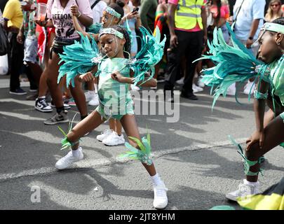 London, UK. 28th Aug, 2022. Girls participate in Notting Hill Carnival in London, UK, on Aug. 28, 2022. Originated in the 1960s, the carnival is a way for Afro-Caribbean communities to celebrate their cultures and traditions. Credit: Li Ying/Xinhua/Alamy Live News Stock Photo