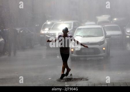 Amman, Jordan. 28th Aug, 2022. A man cools off in a spray of water from a water truck during a heatwave in Amman, Jordan, on Aug. 28, 2022. Jordan's Health Ministry on Sunday warned of high temperatures as a dry heatwave will continue to affect the country for at least two days, advising the public to avoid sunlight exposure. Credit: Mohammad Abu Ghosh/Xinhua/Alamy Live News Stock Photo