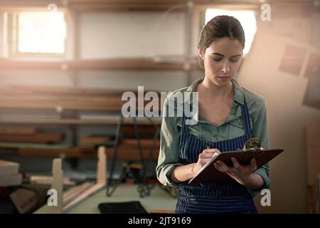 Focussing her creativity. a young female designer in her workshop. Stock Photo