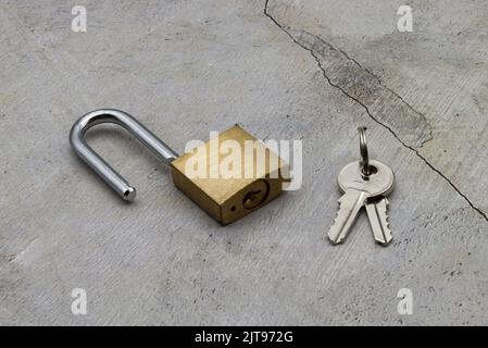 Unlocked padlock with the keys isolated on clear background Stock Photo
