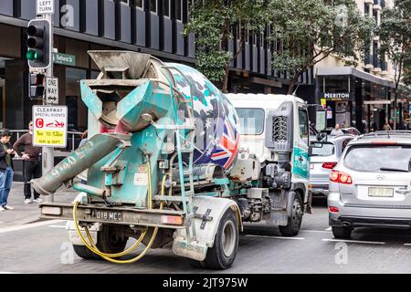 Small ready mix concrete truck in Sydney city centre with australian flag on the drum,Sydney,Australia Stock Photo