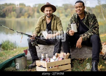 Men with alcohol on fishing outdoors Stock Photo - Alamy