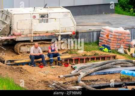 The two workers resting on the construction site Stock Photo