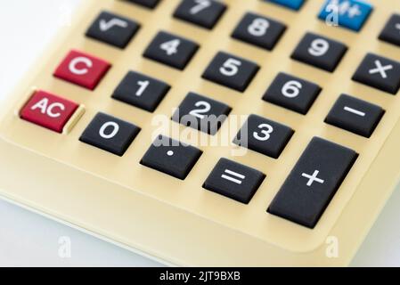 Detail of an old home calculator isolated on white backghround Stock Photo