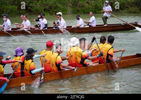 A closeup of People riding dragon boats at Dragon Boat Festival in Tai O, Hong Kong Stock Photo